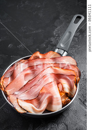 Cooking of Black Forest Ham in skillet. Black background. Top view 86841111
