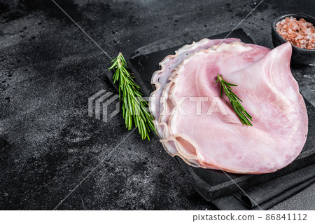 Sliced pork ham on marble board. Black background. Top view. Copy space 86841112