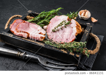 Sliced Smoked gammon - pork shoulder meat with herbs. Black background. Top view 86841131