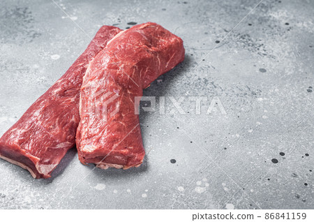 Raw lamb tenderloin Fillet, Mutton Sirloin Meat on butcher table. Gray background. Top view. Copy space Raw lamb tenderloin Fillet, Mutton Sirloin Meat on butcher table. Gray background. Top view. Copy space 86841159
