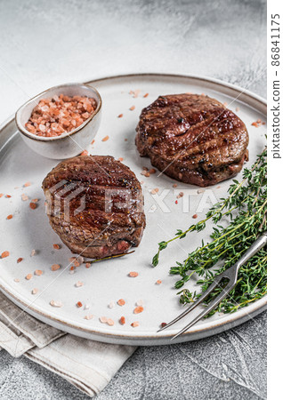 Grilled meat Fillet Mignon steaks from beef tenderloin. White background. Top view 86841175
