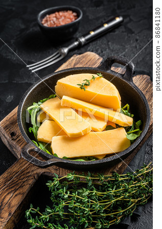 Halloumi cheese in pan ready for grilling. Black background. Top view 86841180