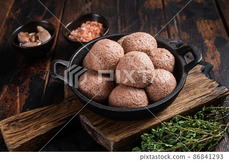 Meatless Vegetarian meatballs from raw plant based meat with thyme and rosemary. Wooden background. Top view 86841293