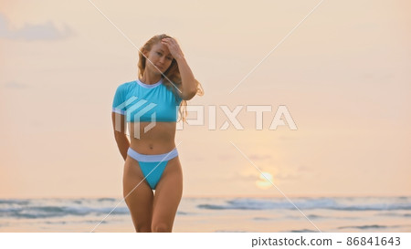 Woman standing on water sea. Girl stand in turquoise swimsuit. Freedom paradise holiday vacation summer beach, seaside landscape concept Woman standing on water sea. Girl stand in turquoise swimsuit. Freedom paradise holiday vacation summer beach, seaside landscape concept 86841643