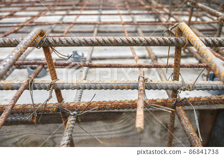 Close up picture of ribbed steel bar reinforcement construction ready for concrete casting, selective focus. Close up picture of ribbed steel bar reinforcement construction ready for concrete casting, selective focus. 86841738