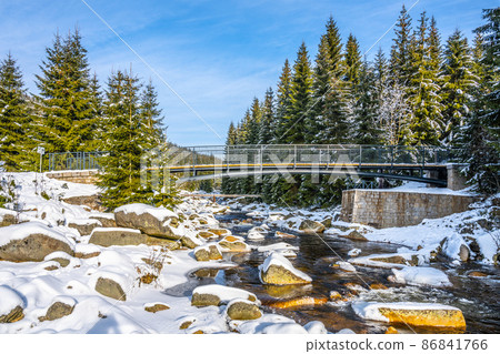 Pedestrian broder bridge over Jizera River in winter 86841766