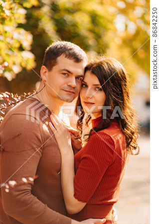 a beautiful, happy couple on an autumn walk.  86842250