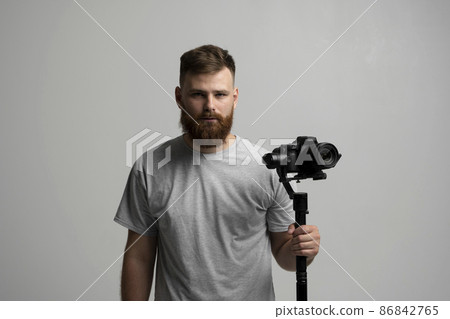 Professional videographer filmmaker cinematographer dop using dslr camera on gimbal stabilizer isolated on white background. Directop of photography, cameraman. 86842765