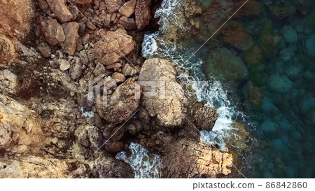 Aerial drone view of the rocky coast and the Mediterranean Sea near the scenic Aphrodite Trail in the Akamas Peninsula National Park, Cyprus. Aerial drone view of the rocky coast and the Mediterranean Sea near the scenic Aphrodite Trail in the Akamas Peninsula National Park, Cyprus. 86842860