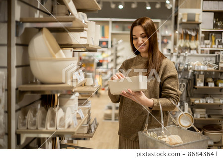 Happy housewife choosing eco friendly ceramic case with wooden lid food storage comfortable placing Happy housewife choosing eco friendly ceramic case with wooden lid food storage comfortable placing 86843641