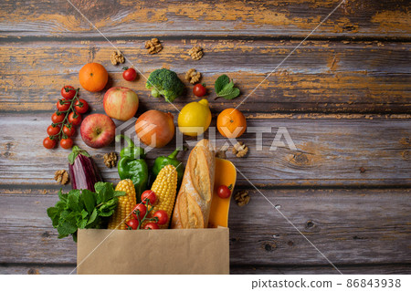 Delivery healthy food background. Healthy vegan vegetarian food in paper bag vegetables and fruits on wood, copy space, banner. Shopping food supermarket and clean vegan eating concept 86843938