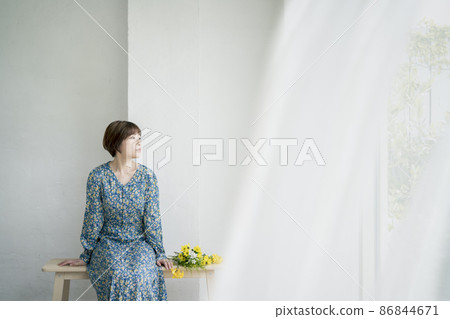 Portrait of a young woman wearing a floral dress 86844671