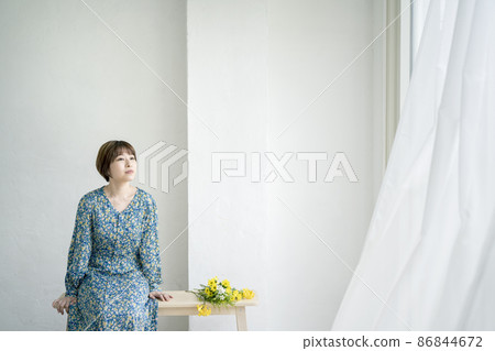 Portrait of a young woman wearing a floral dress 86844672