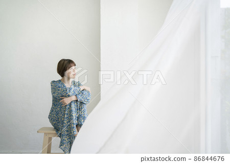 Portrait of a young woman wearing a floral dress 86844676