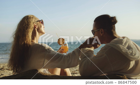 Loving couple in white dress, sunglasses, kissing, relax and dri Loving couple in white dress, sunglasses, kissing, relax and dri 86847500