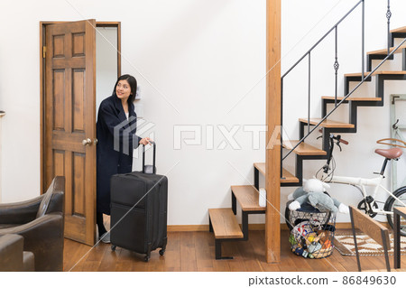 Rental space A young woman who pulls a suitcase (carry back) into the hotel Rental space A young woman who pulls a suitcase (carry back) into the hotel 86849630