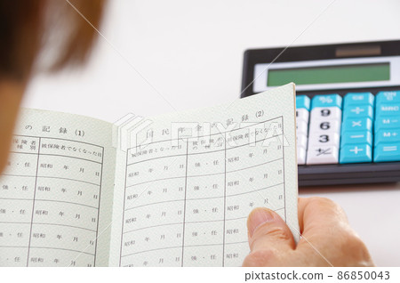 Senior female looking at pension book 86850043