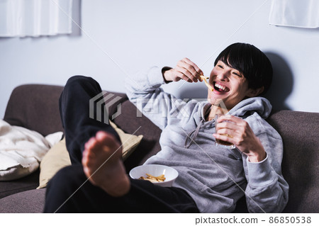 A man enjoying a movie while eating french fries 86850538