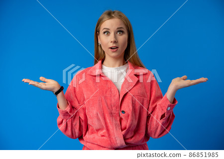 Excited thrilled woman portrait on blue studio background Excited thrilled woman portrait on blue studio background 86851985