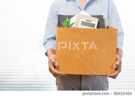 Resignation Concept The male standing and using his hands lifting a box of his stuff 86852460