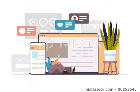 arab man using computer and mobile chatting apps online communication social media network digital addiction arab man using computer and mobile chatting apps online communication social media network digital addiction 86852643