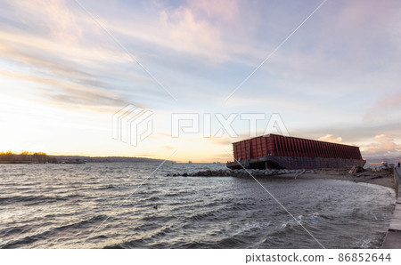 Barge container ship collided on a rocky coast during wind storm. Barge container ship collided on a rocky coast during wind storm. 86852644