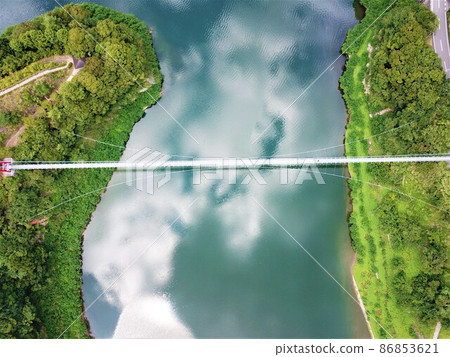 Drone aerial view of Tsubakiyama Lake Bridge and clouds on the lake surface Drone aerial view of Tsubakiyama Lake Bridge and clouds on the lake surface 86853621
