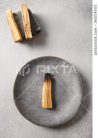 Palo Santo stick incense burning for meditation. Palo Santo stick incense burning for meditation. 86854503