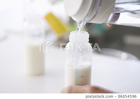 Asian men making milk for twin babies 86854596