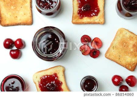 Cherry jam sandwiches and ingredients on white background 86854860