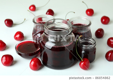 Cherry jam and ingredients on white background 86854862