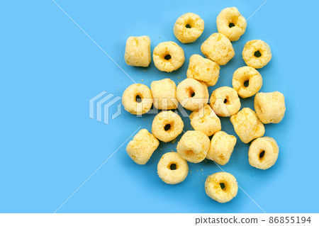 Roller corn snack on blue background. 86855194