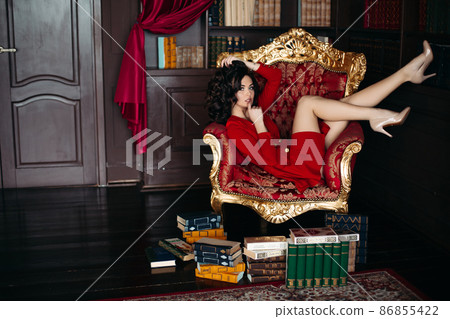 Sexy young brunette lying on big armchair in Sexy young brunette lying on big armchair in 86855422