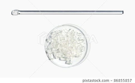 Closeup chemical ingredient on white laboratory table. Sodium Thiosulfate in Chemical Watch Glass placed next to stirring rod. Top View 86855857