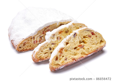Sliced Traditional Christmas stollen cake with marzipan and dried fruit isolated on white background Sliced Traditional Christmas stollen cake with marzipan and dried fruit isolated on white background 86856472