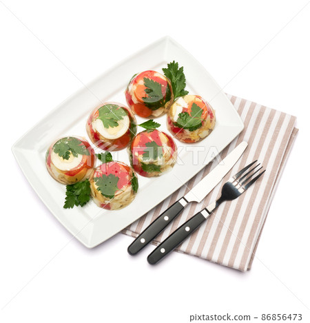 Portion of delicious chicken aspic on a plate isolated on white background Portion of delicious chicken aspic on a plate isolated on white background 86856473
