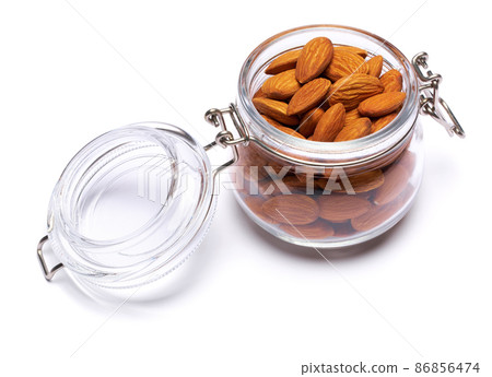 Almond nuts in a glass bowl isolated on a white background 86856474