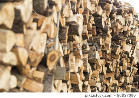 There was a pile of chopped firewood. Folded dry logs of firewood close up. Firewood for winter heating in the countryside 86857090