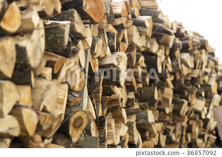 There was a pile of chopped firewood. Folded dry logs of firewood close up. Firewood for winter heating in the countryside 86857092