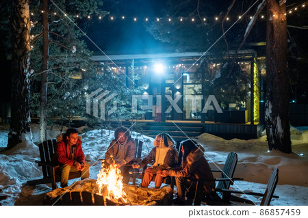 Friends spending winter vacation in the country house Friends spending winter vacation in the country house 86857459