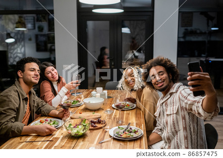 Friends making selfie portrait at dinner party Friends making selfie portrait at dinner party 86857475
