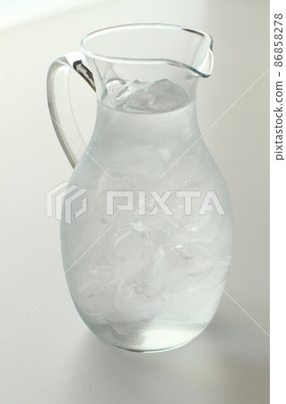 Ice water in a glass pitcher Ice water in a glass pitcher 86858278