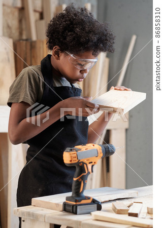 Little Boy Building in Workshop 86858310