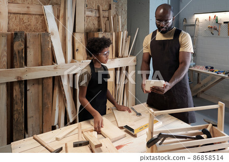 Father and Son in Workshop Together 86858514