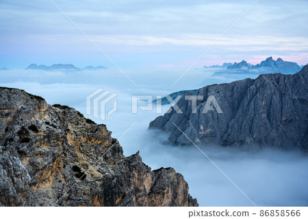 Incredible sunrise with flowing fog in the Dolomites mountains Incredible sunrise with flowing fog in the Dolomites mountains 86858566