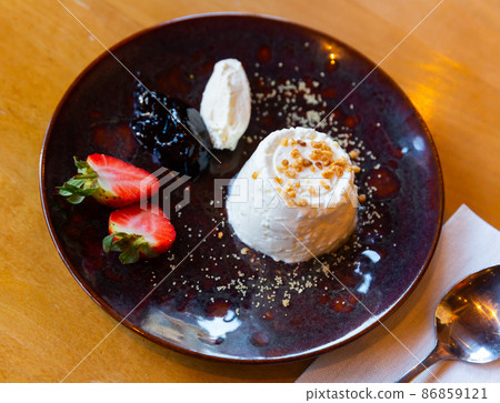 Fresh faisselle de savoie served on table with jam and strawberry 86859121