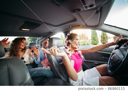 Trendy, stylish, trendy girlfriends go in the car Trendy, stylish, trendy girlfriends go in the car 86860115