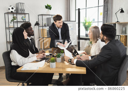 Focused business partners having meeting at boardroom Focused business partners having meeting at boardroom 86860225