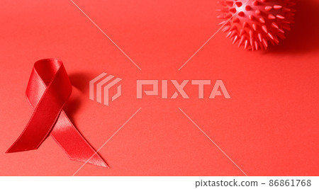 Sign of cancer red ribbon on the table. Sign of cancer red ribbon on the table. 86861768