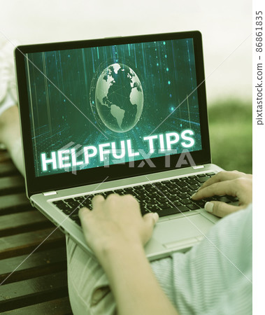 Handwriting text Helpful Tips. Internet Concept service advice help support assistance and quick tips Laptop Resting On Lap Of Woman With Flat Legs Accomplishing Remote Job. 86861835